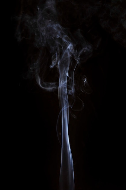 Free Photo movement of white smoke moves upward on black background