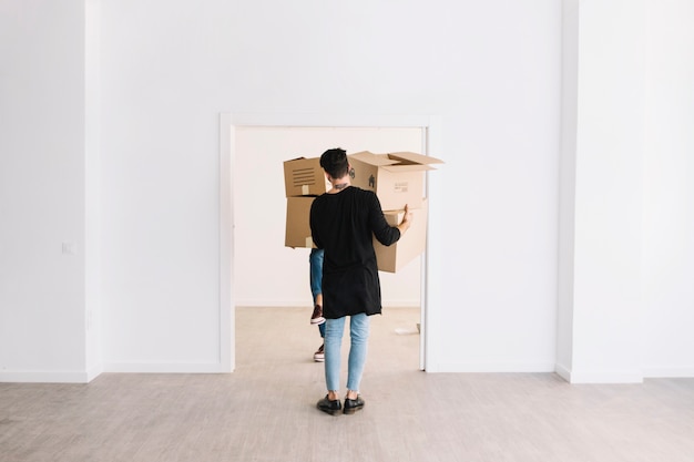 Moving concept with man carrying boxes