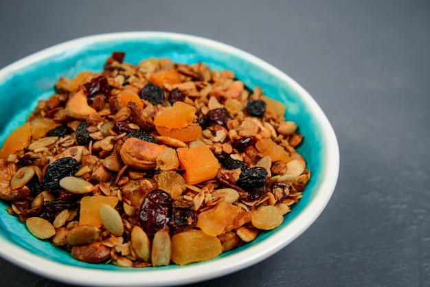 Muesli in plate over gray surface. Close up.