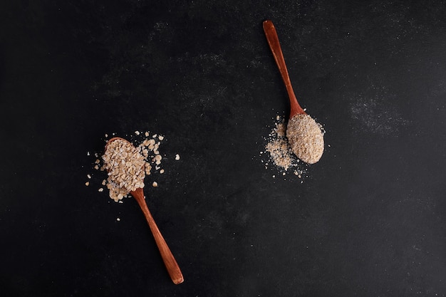 Mueslies in wooden spoons, top view. 