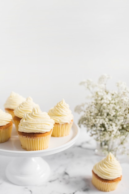 Free photo muffins on cake stand against white background