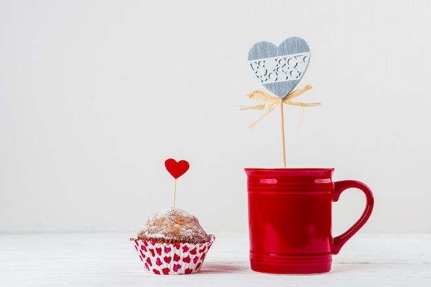 Mug and cake with ornament hearts on wands