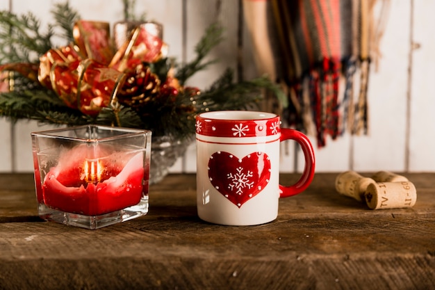 Mug and candle on wooden tabletop