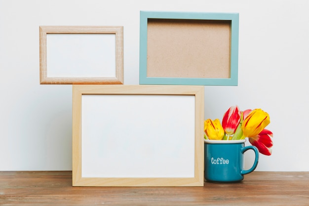 Mug with tulips near frames