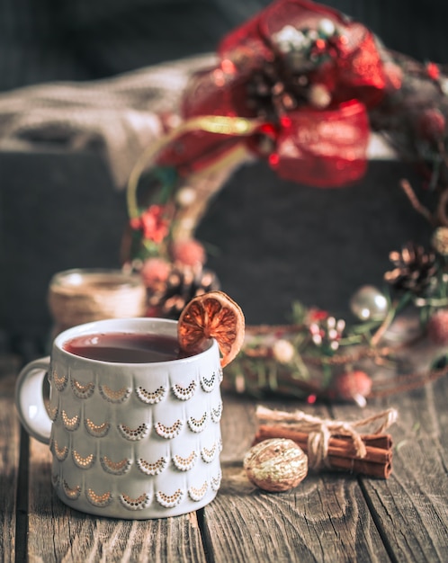 mulled wine in a cup on a wooden background