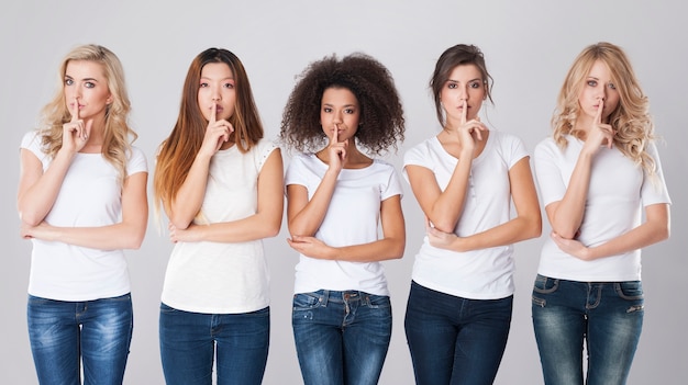 Free photo multi ethnic women with silence sign