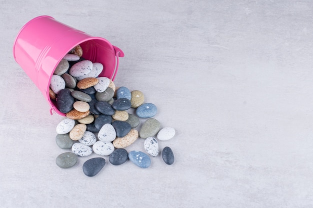 Free photo multicolor beach stones for crafting on concrete surface