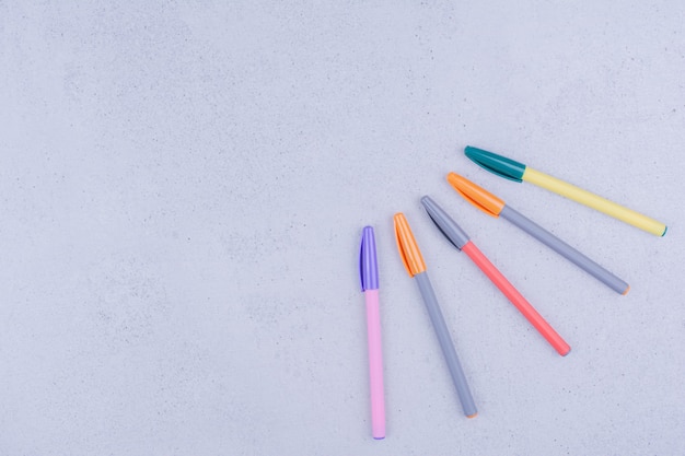 Multicolor mandala craft pencils isolated on grey surface