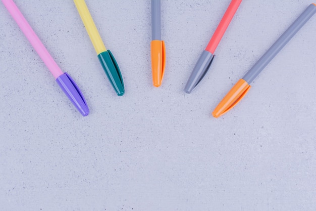 Multicolor pens for mandala coloring on grey.