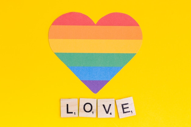 Free photo multicolored lgbt heart with love lettering