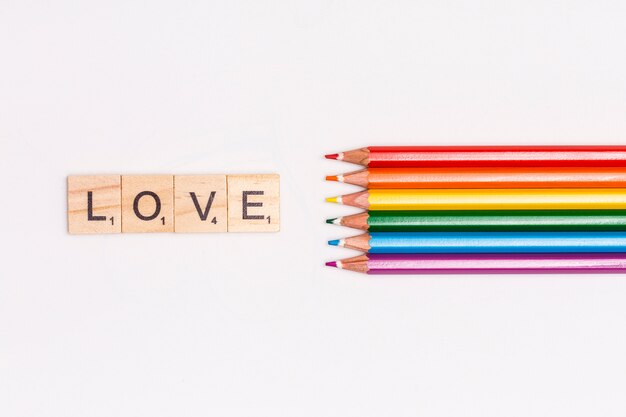 Multicolored pencils and LOVE lettering