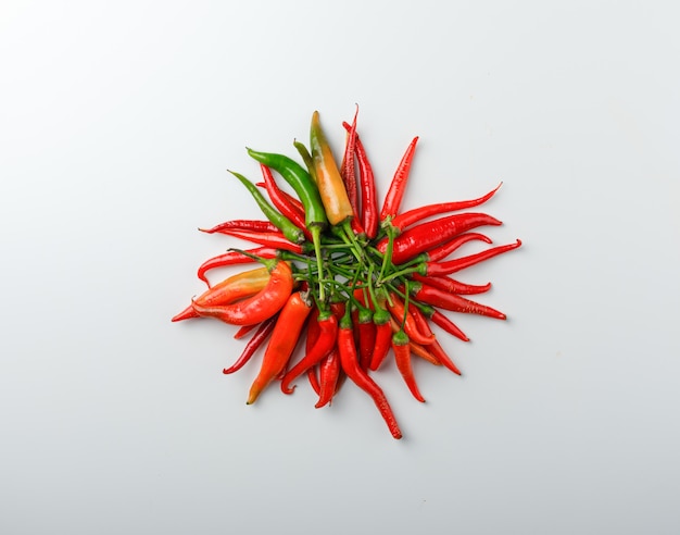 Free photo multicolored peppers top view on a white background