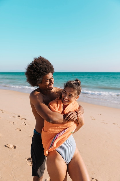 Multicultural couple having fun on beach