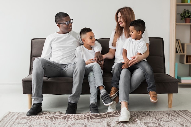 Multicultural family spending time together on the couch