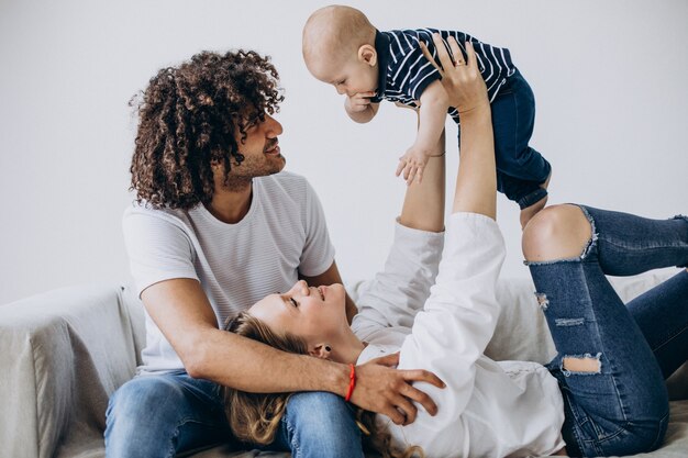 Multicultural family with their little son having fun together