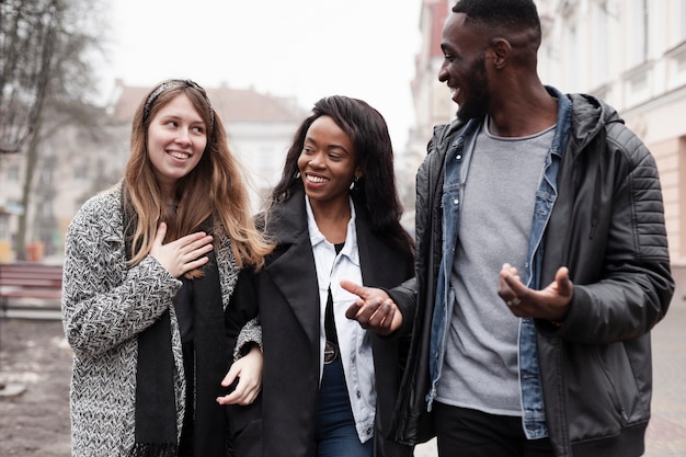 Multicultural friends laughing together medium shot