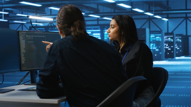 Free Photo multiethnic colleagues overseeing supercomputers in data center