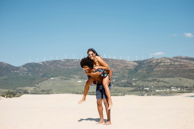 Multiethnic couple having fun on beach