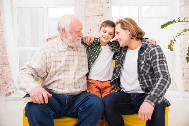 Free photo multigenerational men hugging with love