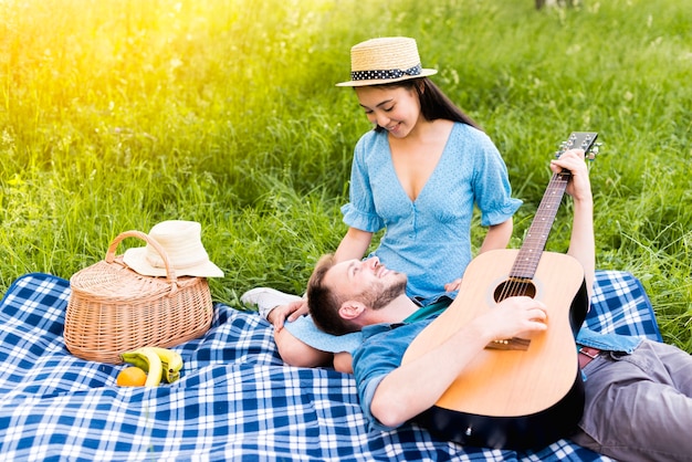 Free photo multiracial adult couple having picnic