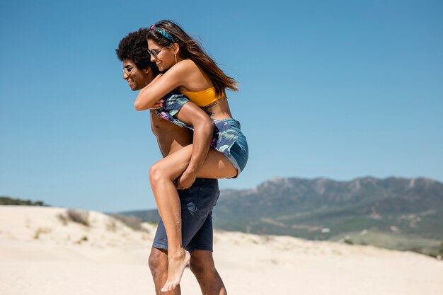 Multiracial couple walking on beach