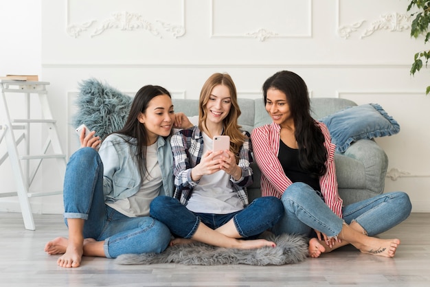 Multiracial girlfriends photographed on phone