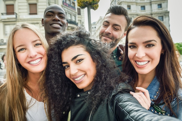 Multiracial group of young people taking selfie