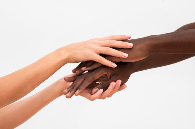 Multiracial hands coming together