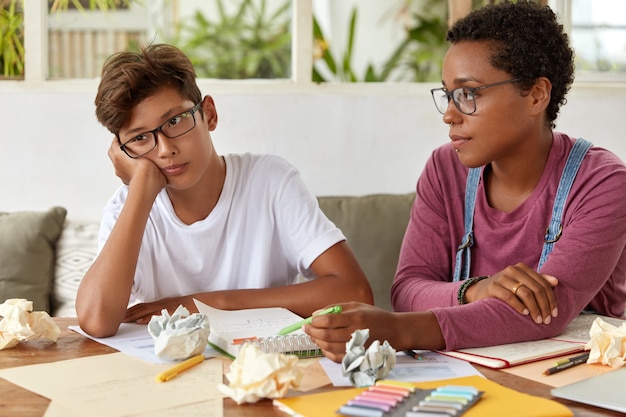 Multiracial teenagers do homework together