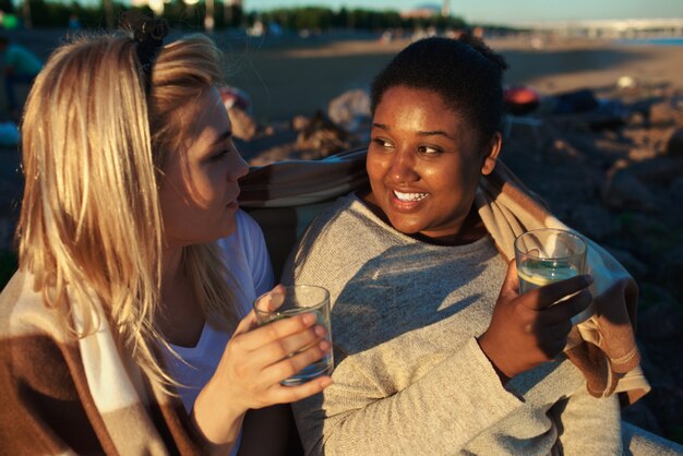 Multiracial women drinking on party