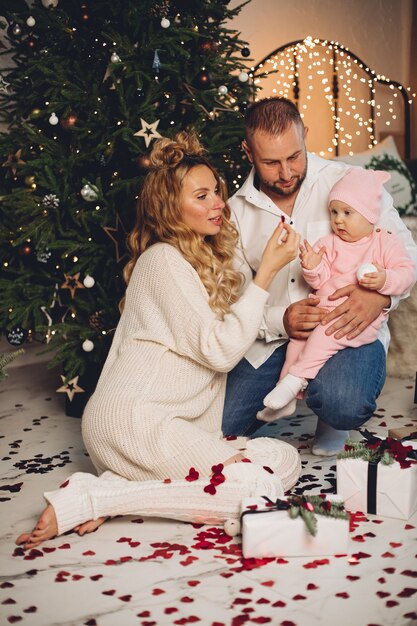 Mum and dad rejoices with their little child in the same sleepwear