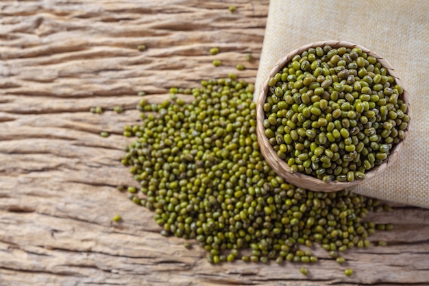 Mung bean seeds on a wooden background in the kitchen