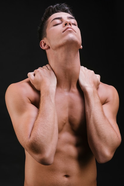 Muscular man stretching neck