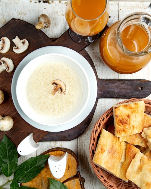 Mushroom cream soup on a wooden board