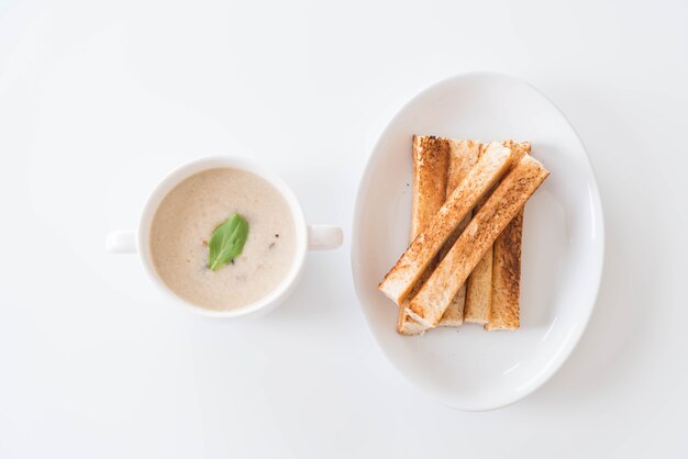 mushroom soup and bread in white ceramic cup