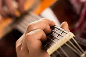 Free photo music, close-up. musician holding a wooden guitar