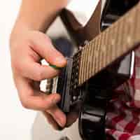 Free photo music, close-up. young musician holding electro guitar