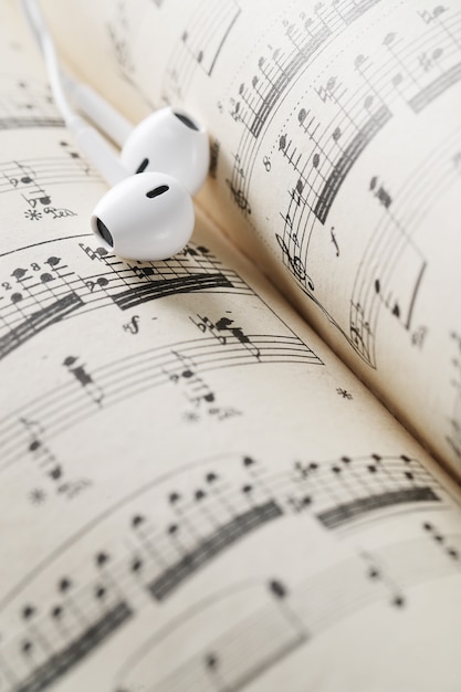 Free photo music notes sheet and earphones