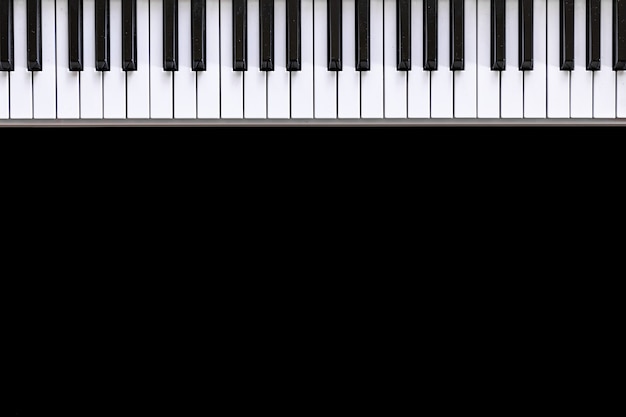 Free photo musical background with musical keys on black, flat lay, copy space.