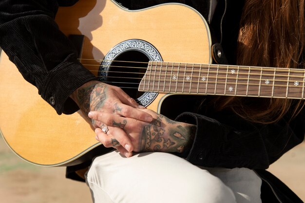 Musician holding the guitar in the streets