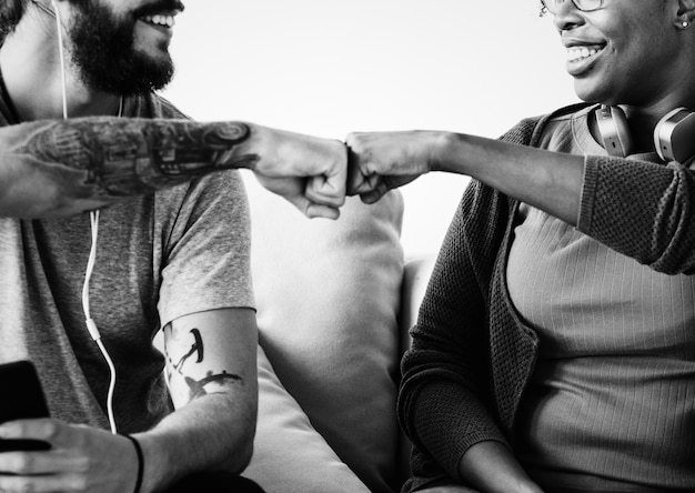 Free Photo musicians fist bumping on a couch