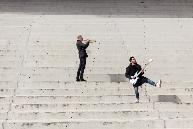 Free photo musicians performing on concrete stais