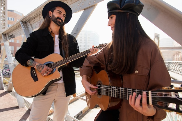 Free photo musicians playing the guitar in the streets and having fun