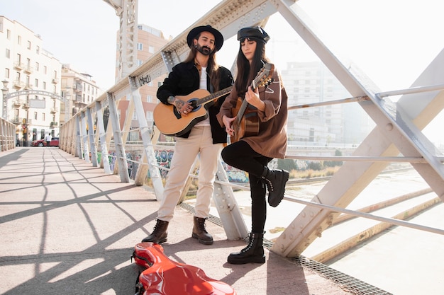 Free photo musicians playing the guitar in the streets