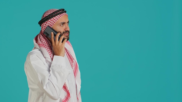 Free photo muslim adult taking incoming phone call