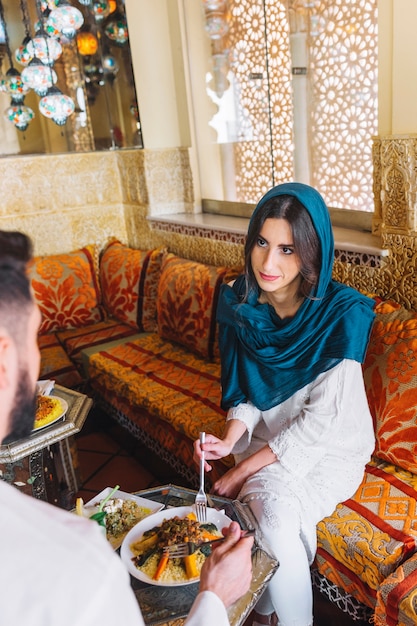 Muslim couple talking in arab restaurant