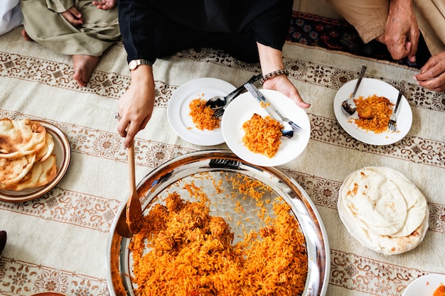 Free Photo muslim family having dinner on the floor