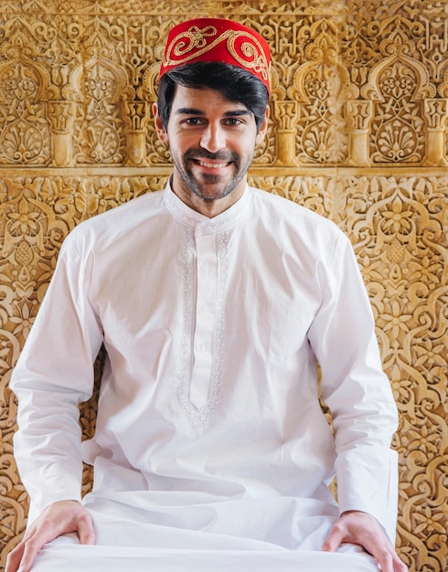 Free Photo muslim man in front of golden wall