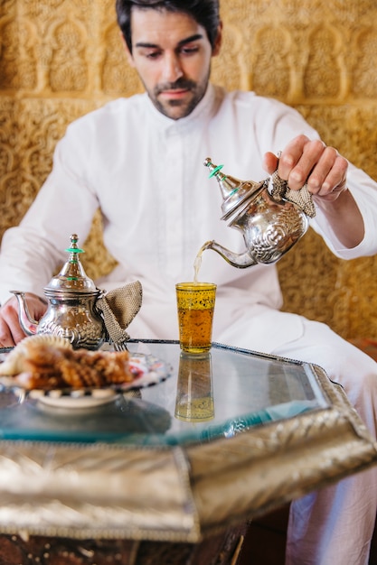 Free Photo muslim man pouring tea