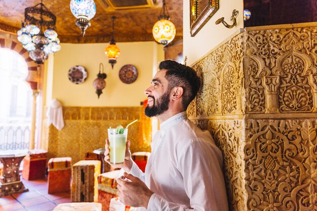 Muslim man sitting in restaurant